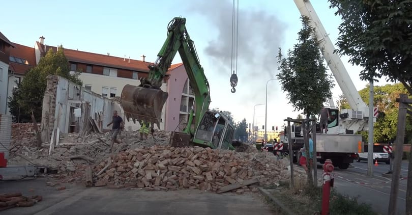 Videón, ahogy kiszabadítják a pincébe zuhant 20 tonnás markolót Szombathelyen