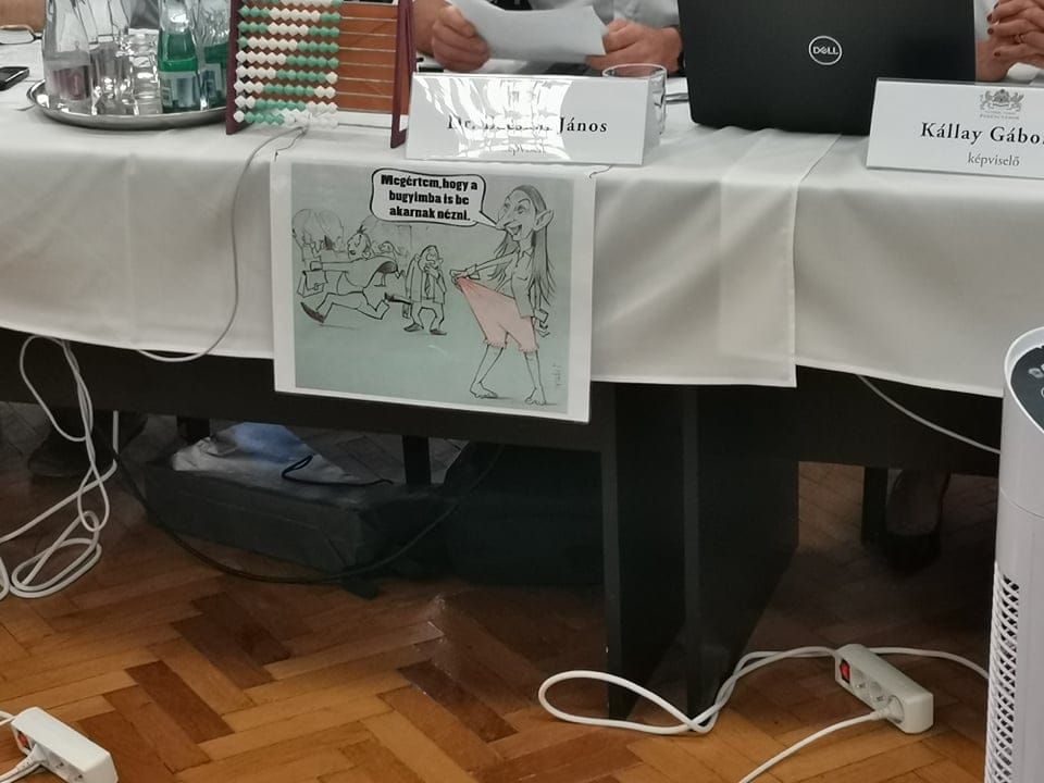 Egy Baranyi Krisztinát ábrázoló gúnyrajz lóg elődje, Bácskai János asztalán a közgyűlésen