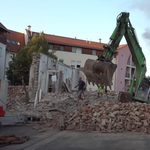 Videón, ahogy kiszabadítják a pincébe zuhant 20 tonnás markolót Szombathelyen