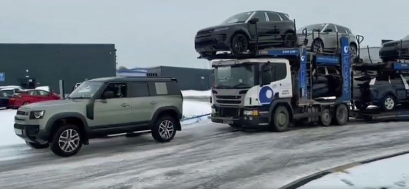 A kereskedés előtt álló vadonatúj Land Rover Defender húzta ki a bajból az autószállító kamiont – videó